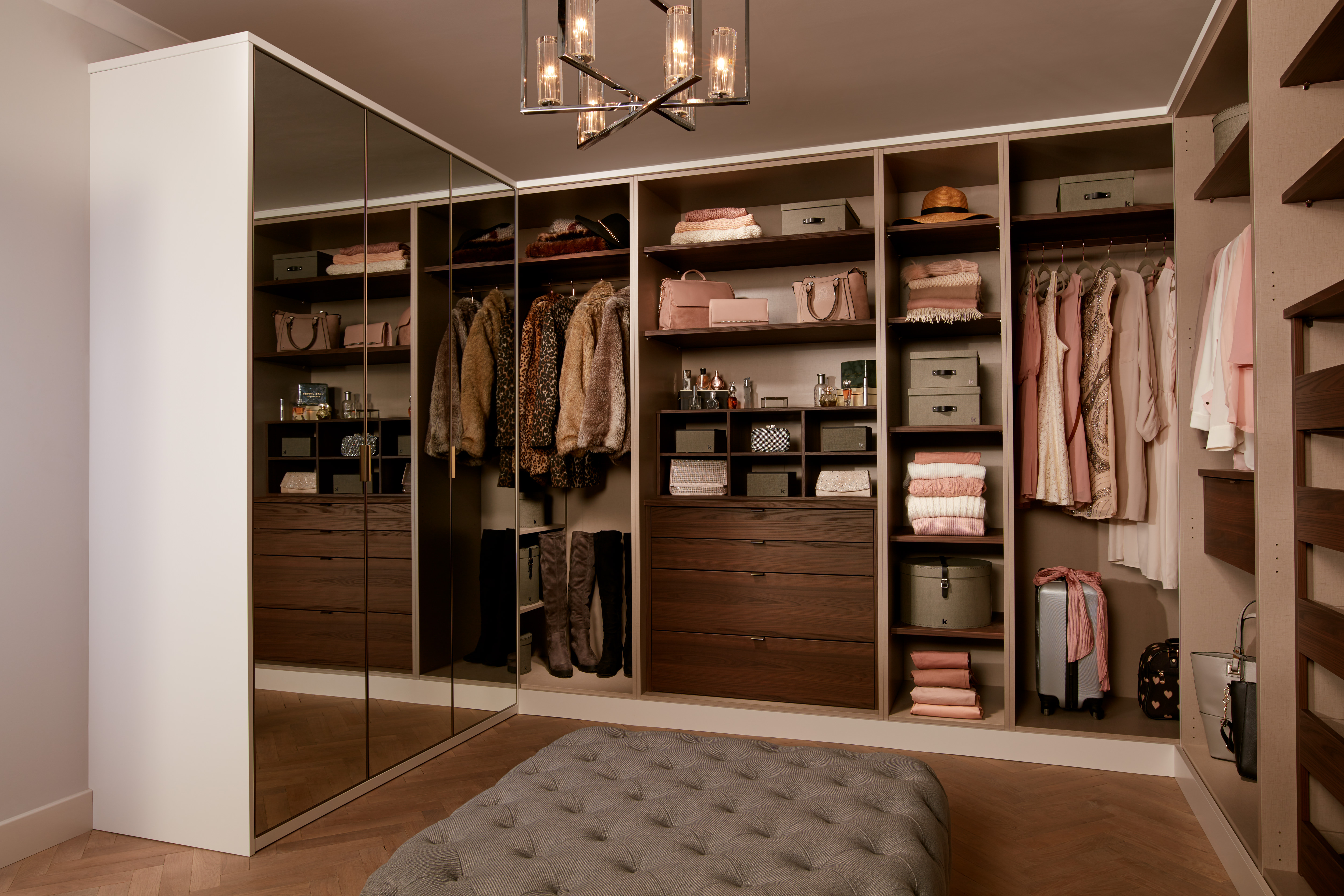 Walk-in wardrobe with mirrored doors and walnut interior